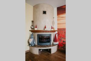 a living room with a fireplace with christmas decorations at Lovely apartment for families and couples in Liepāja +7 photos