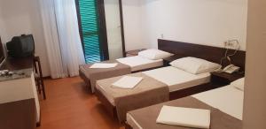 Postel nebo postele na pokoji v ubytování Hotel Zenit Neum