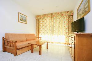 a living room filled with furniture and a tv at Zahara Rentalmar in Salou