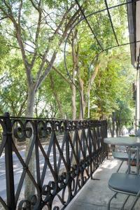 a wrought iron fence with a table and chairs at White Orchid Pula in Pula