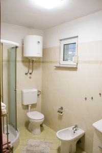 a bathroom with a toilet and a sink at White Orchid Pula in Pula +52 photos