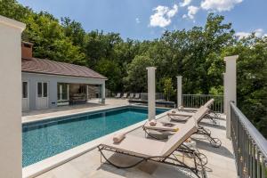 a swimming pool with two lounge chairs next to a house at Villa Grey Stone in Gata