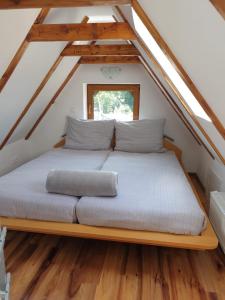 a bed in the attic of a house at Apartamenty Krótka 3 in Świeradów-Zdrój