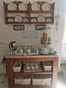 a shelf filled with lots of dishes and baskets at Affittacamere Alisso in Olbia +34 photos