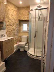 um banheiro com chuveiro, vaso sanitário e pia em Maison de pêcheur de 1820 au cœur du bourg - 3 étoiles em Ouistreham