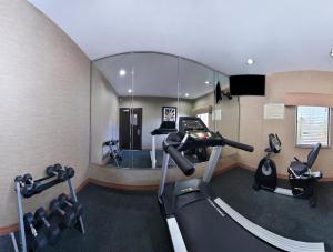 a room with a gym with two tread machines and a mirror at Americas Best Value Inn Cuero in Cuero