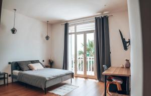 a bedroom with a bed and a large window at La Maison Mickael in Marseille