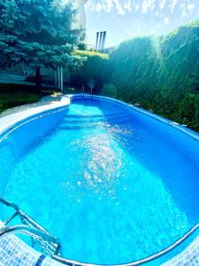 a large swimming pool with blue water at Ridon Lux Hotel in Tashkent