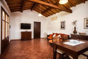 a living room with a table and a tv at Casa vacanza Asfodeli in Teulada