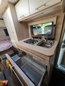 an interior view of a kitchen in an rv at Caravane tractable in Paliseul