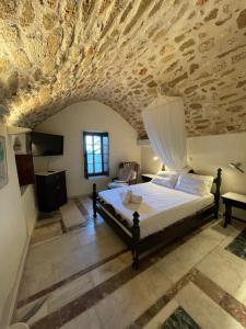 a bedroom with a bed and a stone ceiling at Astrolithos Castle in Monemvasia