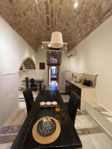 a dining room with a table and a kitchen at Astrolithos Castle in Monemvasia