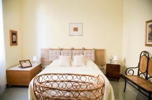 a bedroom with a large bed and a chair at Casa Terracotta in Matera