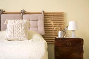 a bedroom with a bed and a nightstand with a lamp at Casa Terracotta in Matera