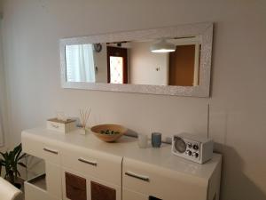 tocador blanco con microondas y espejo en Room Mina, en Rovinj
