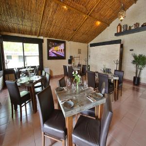 a dining room with tables and chairs in a restaurant at Real de Corralejo in San Miguel de Allende