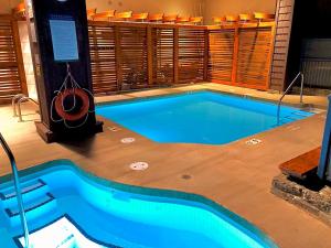 a swimming pool in a building with a pool at Spectacular Location with Pool and Hot Tub by Harmony Whistler in Whistler