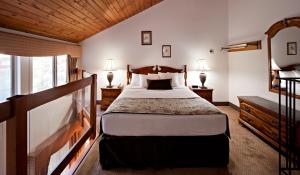 a bedroom with a bed and two lamps and a window at Charltons Banff in Banff