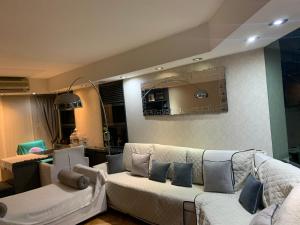 a living room with two white couches and blue pillows at Tagle-Recoleta in Buenos Aires