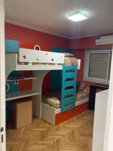 a bedroom with two bunk beds and a desk at Tagle-Recoleta in Buenos Aires