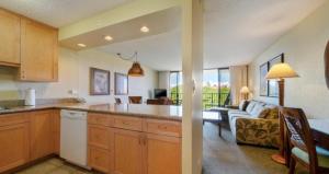 a kitchen and a living room with a couch at Ocean View Getaway at Aston Ka'anapali Shores in Lahaina