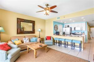 a living room with a couch and a table at Splash Condo, Aqua Park, Lazy River in Panama City Beach