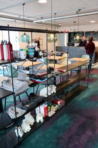 a room with tables and shelves with stuffed animals at Hotel Aurora in Nuuk