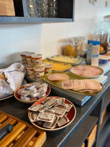 a buffet with plates of food on a counter at Hotel Aurora in Nuuk