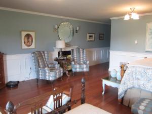 a bedroom with a bed and two chairs and a table at Casa Breeze B & B in Saint Stephen
