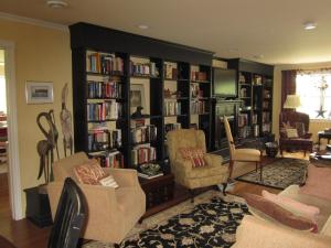 a living room with book shelves filled with books at Casa Breeze B & B in Saint Stephen