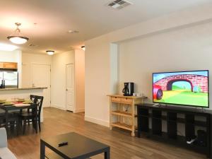 a living room with a flat screen tv on a wall at Perfect Apt near UCLA w Parking Gym Pool WIFI in Westwood B3 in Los Angeles
