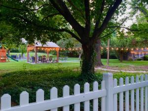 a white fence in front of a park with a gazebo at Roadhaven1830 in Mount Jackson