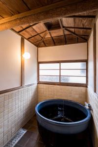 a large blue tub in a room with a window at 平野邸 Hayama in Hayama