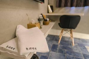a chair and a pillow in a room at 澎湖海景民宿 島嶼時光 Island Time Homestay in Magong