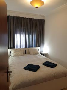カバナス・デ・タビラにあるHOME4U - Cosy Apartment with Fantastic Terraceのベッドルーム1室(ベッド1台、タオル2枚付)