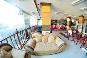 a living room with a couch on a balcony at Honey Hunt House in Cebu City