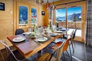 a dining room with a large wooden table and chairs at Chalet Carter - OVO Network in Saint-Jean-de-Sixt