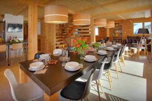 a dining room with a long table and chairs at Chalet Crechoua - OVO Network in La Giettaz