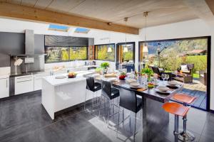 a kitchen with a large island with a dining table at Chalet de Rollon - OVO Network in Thônes