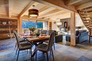 a dining room with a table and chairs at Chalet Les Brévins - OVO Network in Manigod