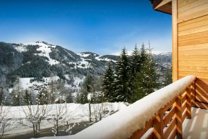 a winter view from the balcony of a cabin at Chalet La Frasse - OVO Network in La Clusaz