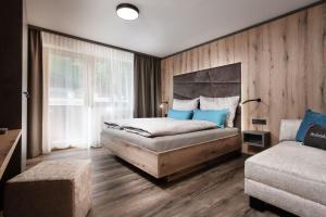 a bedroom with a large bed with blue pillows at Apartments Niederseer in Saalbach Hinterglemm