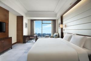 a hotel room with a large bed and a television at Crowne Plaza Nanchang Riverside, an IHG Hotel in Nanchang