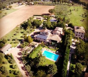 an aerial view of a large house with a swimming pool at Casale Dolci Dimore in Massa Martana