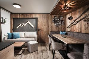 a living room with a couch and a table at Apartments Niederseer in Saalbach-Hinterglemm