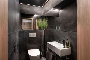 a bathroom with a white sink and a toilet at Apartments Niederseer in Saalbach Hinterglemm