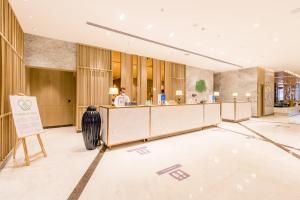 a lobby with a reception desk in a building at Holiday Inn Chandigarh Zirakpur, an IHG Hotel in Chandīgarh