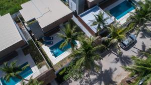 an overhead view of palm trees in front of a building at Dhevan Dara Resort & Spa Hua Hin - Pool Villa in Hua Hin