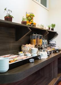 a buffet line with food on a table at Hotel Metropol Basel in Basel