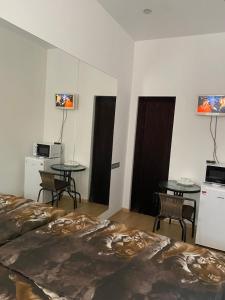 a hotel room with two tables and two beds at Olesi Gonhara in Dnipro +9 photos
